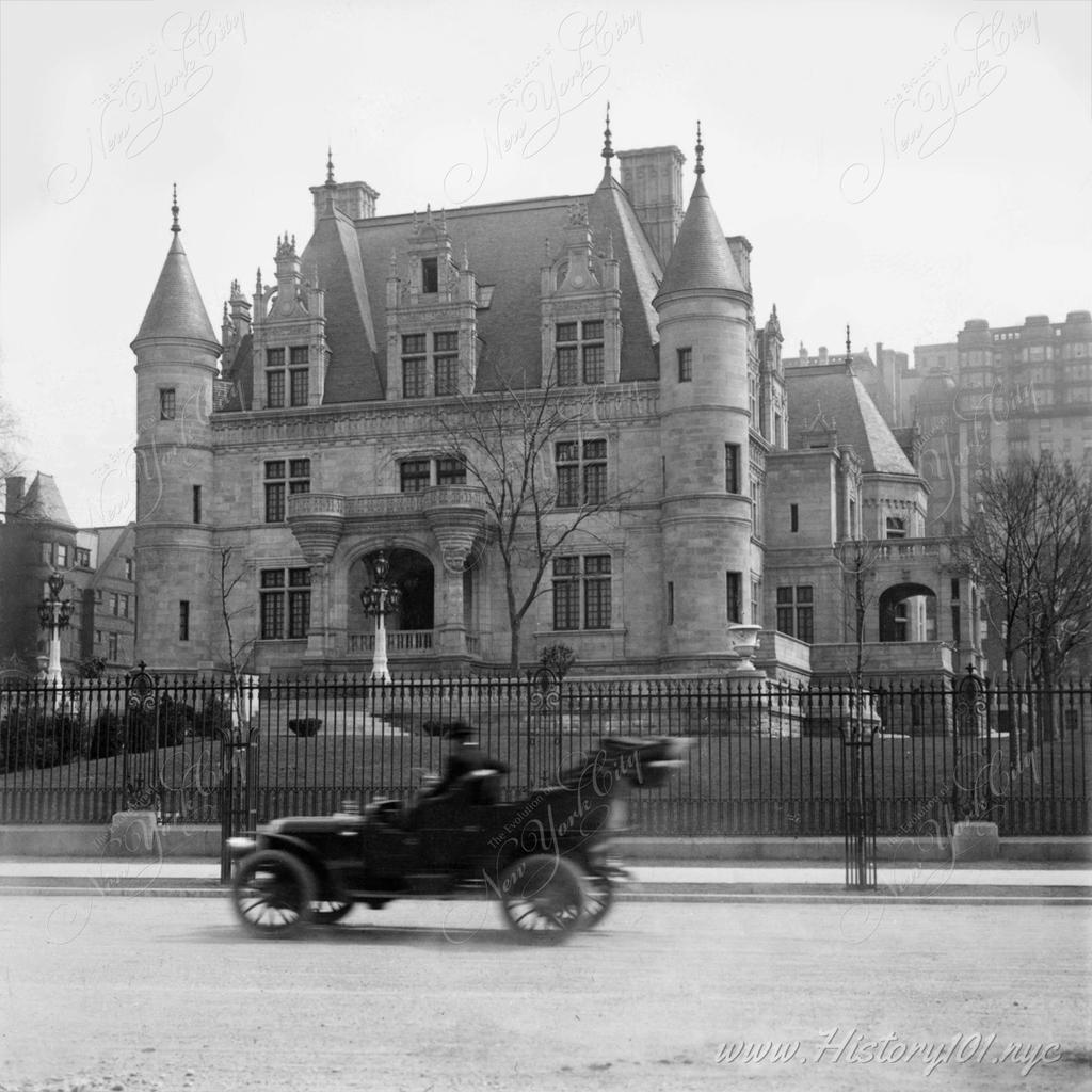 Photograph of an automobile passing in front of the residence of Charles Schwab on Riverside Drive,