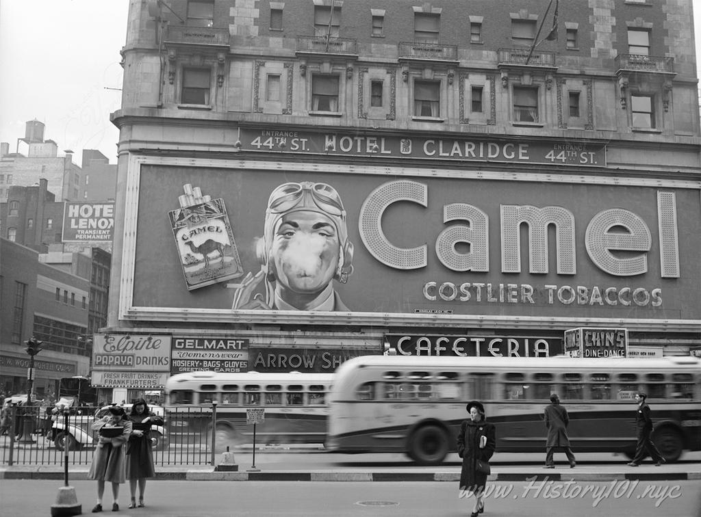 Photograph of an iconic Times Square advertisement for Camel Cigarettes, featuring actual smoke blowing onto the street.